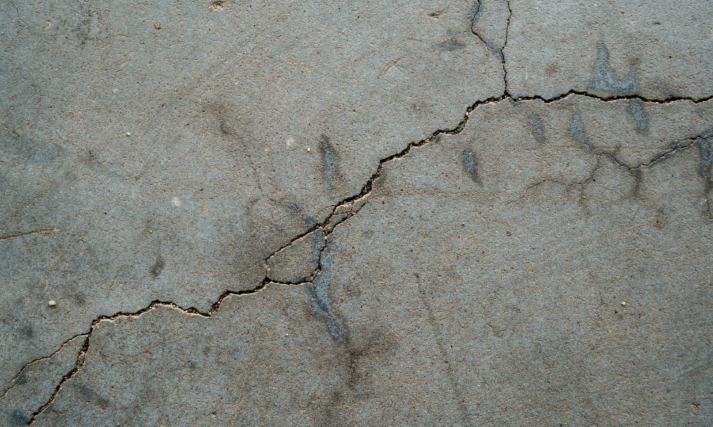 cracked concrete floor, needing preparation before replacement